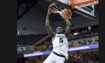 Missouri guard D'Moi Hodge hangs on the rum after dunking against Southern indiana on Nov. 7 at Mizzou Arena. * Photo credit: Amy Schaffer/Missourian