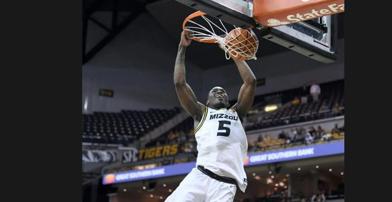 Missouri guard D'Moi Hodge hangs on the rum after dunking against Southern indiana on Nov. 7 at Mizzou Arena. * Photo credit: Amy Schaffer/Missourian