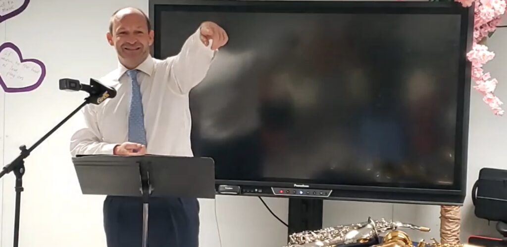 Richard May, managing partner at Maples and Calder, gestures as he delivers remarks at the handing-over ceremony of musical equipment to the Elmore Stoutt High School Music Programme on Wednesday.